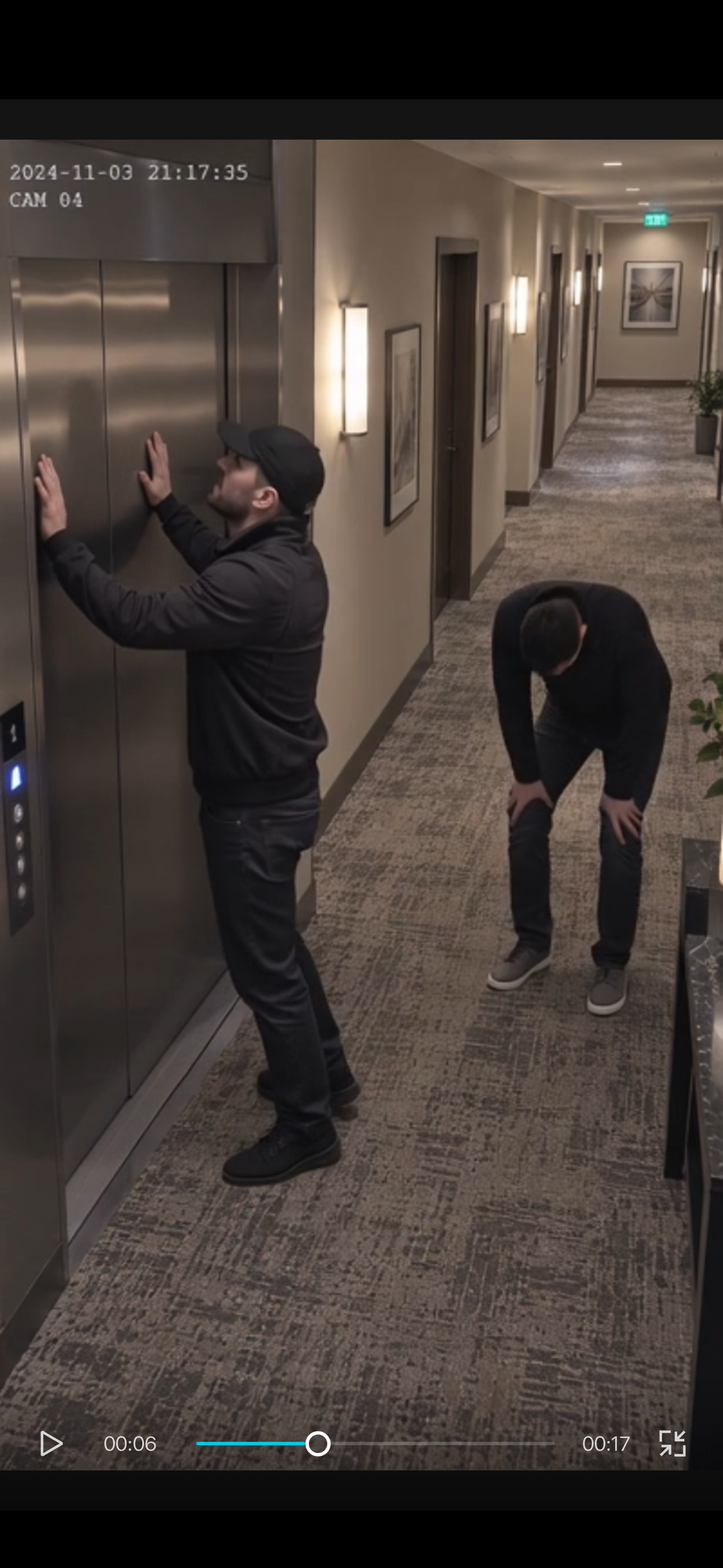 Two men outside the closed elevator at 21:17:35