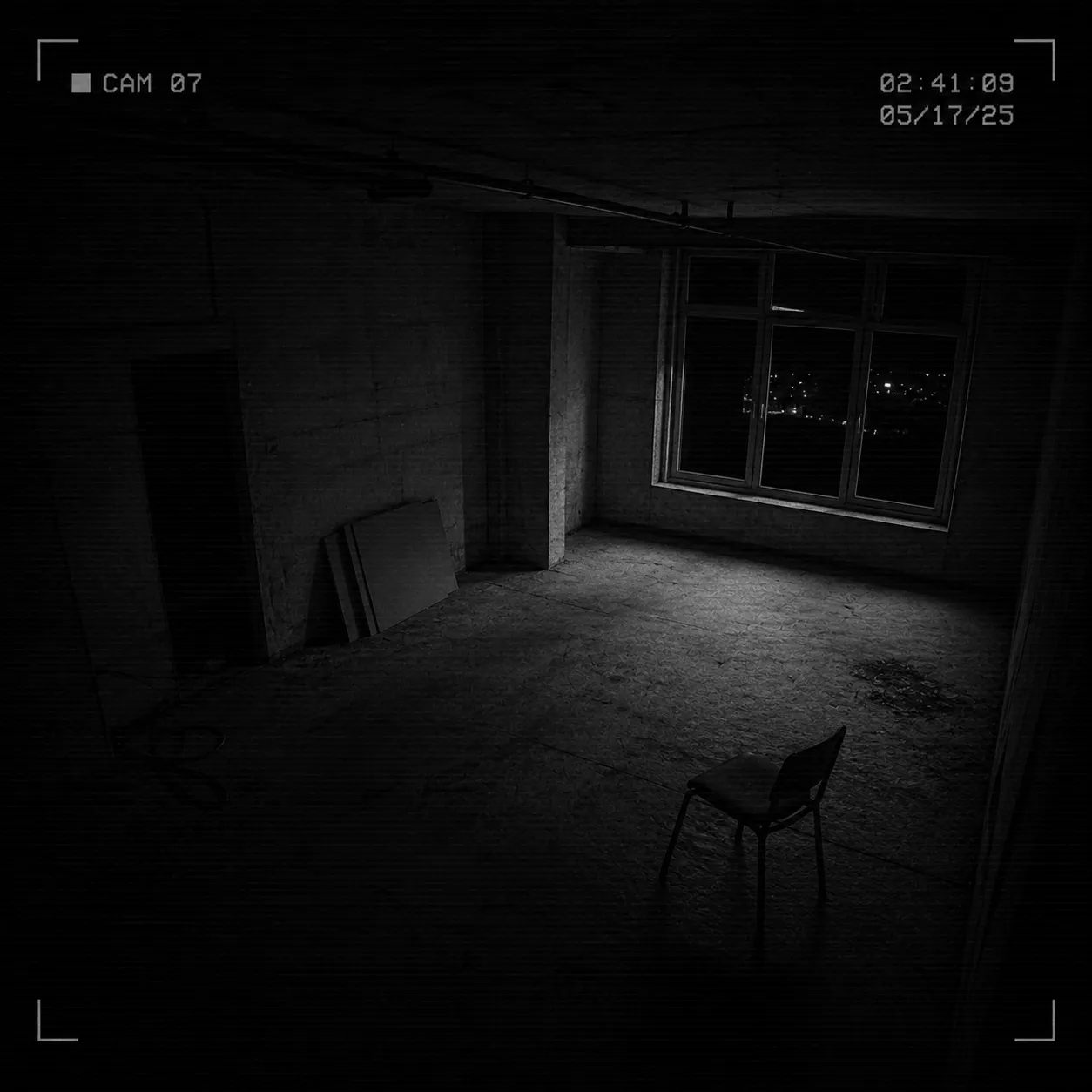 CCTV case frame showing an empty room with a chair and window